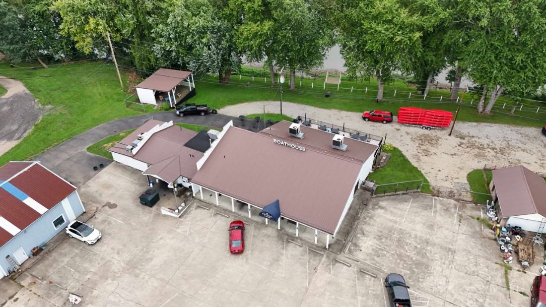 Aerial view of The Boathouse Tavern and the livery parking lot beside the river