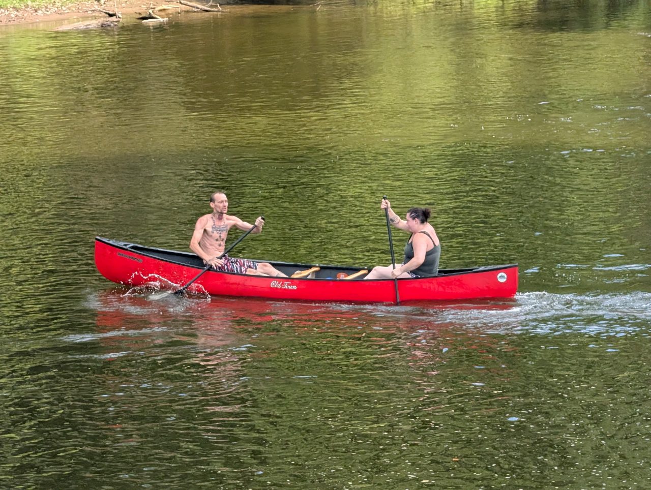 Two paddlers in an Old Town canoe from Roscoe Village Canoe Livery