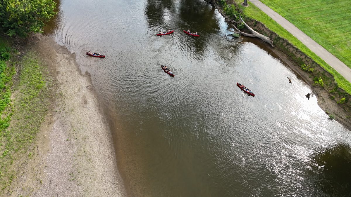 Canoes spread across the river below a gravel bar on the Eagle Trip