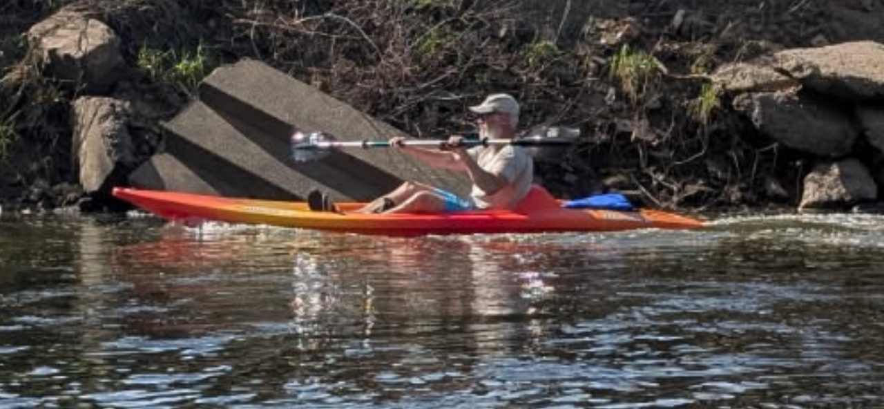 A paddler on the river in a Roscoe Village Canoe Livery kayak