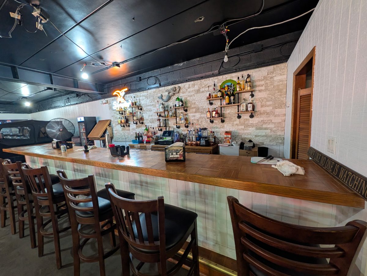 The bar at The Boathouse Tavern, stocked and ready with seating along the rail